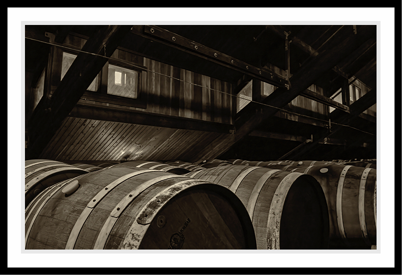 Barrels in an attic holding wine.